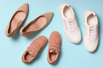 Classic hard-heeled shoes, sneakers and shoes for children on a colored background top view. Footwear for children and adults.