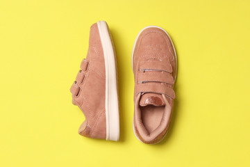  Children's shoes on a colored background top view. Children's footwear.
