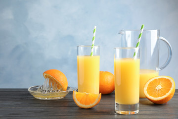 Composition with orange juice and fresh fruit on table. Space for text