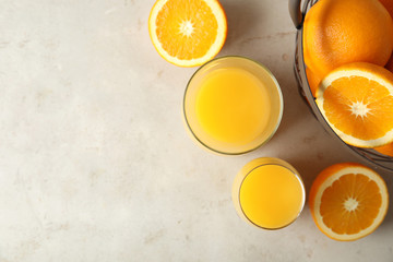 Flat lay composition with orange juice, fresh fruit and space for text on color background