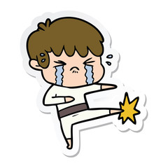 sticker of a cartoon boy crying