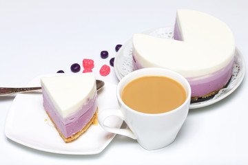 Blueberry cheesecake. A piece of ready-made dessert on a saucer. Jelly layers of different colors are visible.
