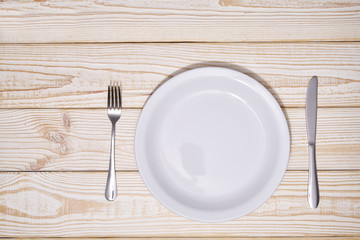 Food concept,  empty white plate on a wooden background.