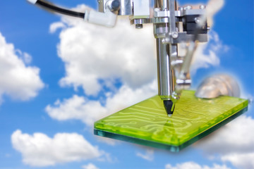 soldering iron tips of automated manufacturing soldering and assembly printed electric circuit board on blue sky and cloud background