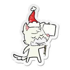 friendly distressed sticker cartoon of a fox wearing santa hat