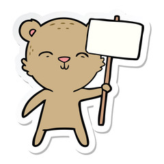 sticker of a happy cartoon bear with sign
