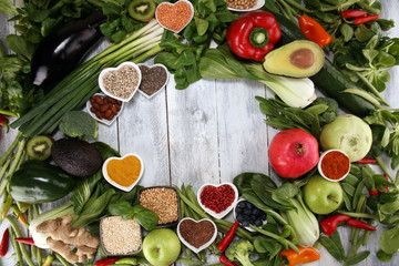 Healthy food clean eating selection. fruit, vegetable, seeds, superfood, cereals, leaf vegetable on rustic background