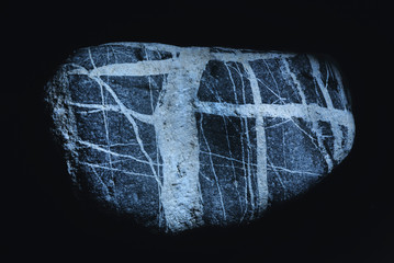 Stone with abstract pattern of white lines