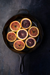 Sliced blood oranges in pan 