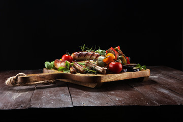 Assorted delicious grilled meat with vegetable on a barbecue. Grilled pork shish or kebab on...