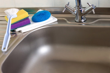 On the kitchen sink are items for cleaning the kitchen