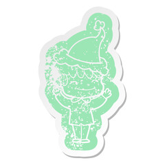 cartoon distressed sticker of a happy boy wearing santa hat