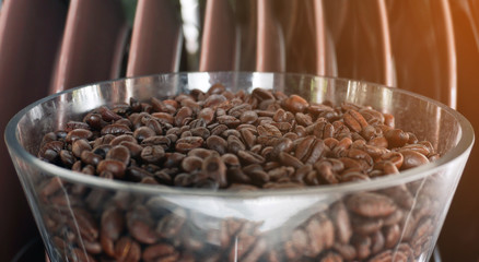 Brown roasted coffee beans on the bowl.