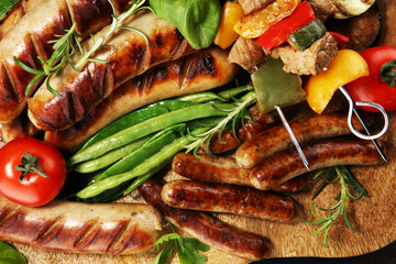 Assorted delicious grilled meat with vegetable on a barbecue. Grilled pork shish or kebab on skewers with vegetables . Food background shashlik