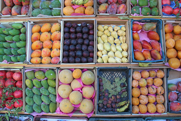 Fruit market with mangoes, pomegranates, bananas, plums, guava, oranges