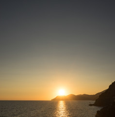 Golden sunset at the cliff at the Italian Riviera in the Village of Riomaggiore, Cinque Terre, Italy