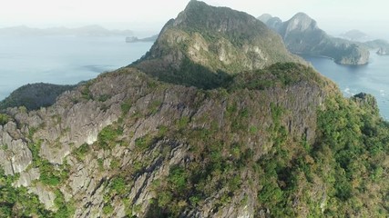 Aerial drone shot of high mountain covered with tropical forest. Tropical landscape. Travel concept Philippines,El Nido.