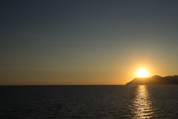 Fototapeta na wymiar Golden sunset at the cliff at the Italian Riviera in the Village of Riomaggiore, Cinque Terre, Italy