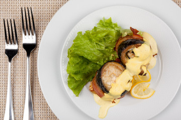 Eggplant and bacon rolls with cheese, lemon and green salad.