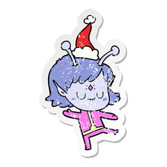 distressed sticker cartoon of a alien girl wearing santa hat