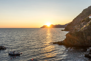 Golden sunset at the cliff at the Italian Riviera in the Village of Riomaggiore, Cinque Terre, Italy