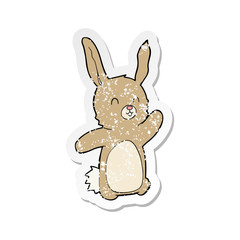 retro distressed sticker of a cartoon happy rabbit