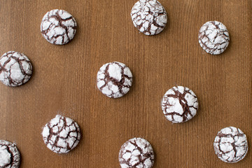 crack cookies on a wooden table with white icing sugar