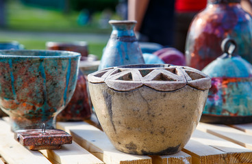 Background from small ceramic multicolored jugs and cups.