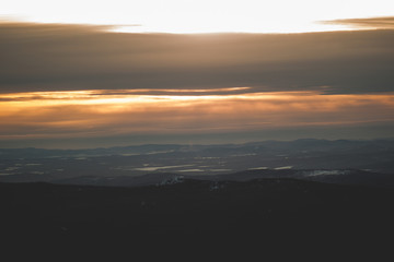 View of the taiga and mountains in the background of sunset during the winter