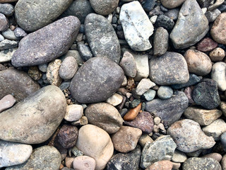 Sea stones background, little rocks, small, stones, in many shades of grey, white and blue, texture of little rocks
