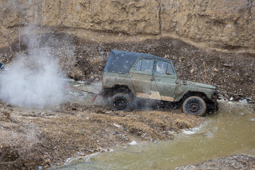 Obraz na płótnie Canvas Russian SUV, Off-road vehicle slips, Stuck in the river 