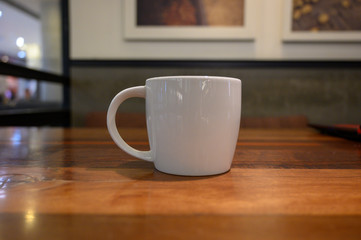 coffee cup on the wood table close up