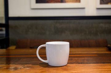 coffee cup on the wood table close up