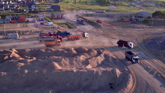 Extraction of construction sand at the quarry. Loading construction sand in trucks.