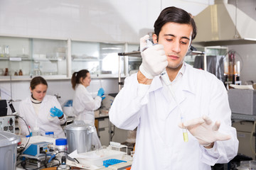 Fototapeta premium Chemist mixing reagents