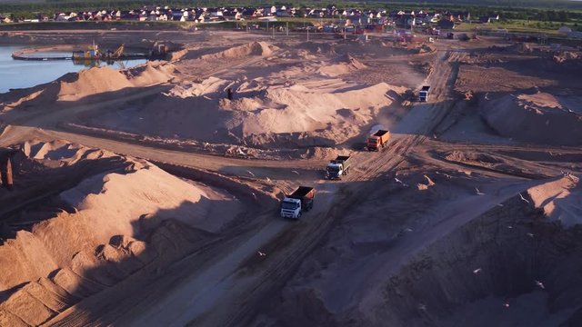 Extraction of construction sand at the quarry. Loading construction sand in trucks.