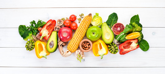 Foods containing natural fiber: avocados, kiwi, apple, tomatoes, spinach, paprika, orange, lemon. Top view. Free space for your text. On a white background.