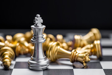 Chess (King wins the game) on black background. Success, business strategy, victory, win, winner, intellect, tactics, defeat, beat, knock, checkmate, leader or leadership concept.