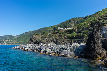 Italy,Cinque Terre,Riomaggiore, a large body of water with a mountain in the background