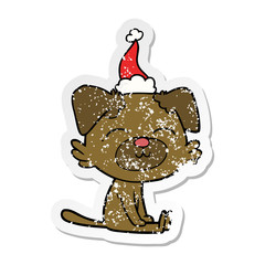 distressed sticker cartoon of a dog wearing santa hat