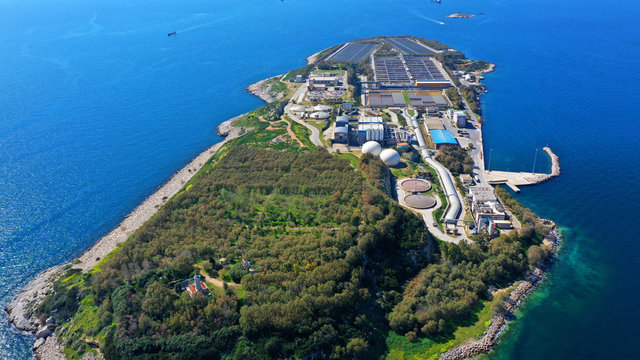 Aerial drone bird's eye view photo from island of Psitaleia the largest sewage treatment plant in Europe, Saronic gulf, Peiraeus, Attica, Greece