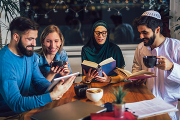 Group of students of diverse ethnic learning at home. Learning and preparing for university exam, selective focus.