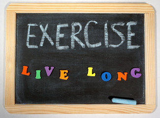 Fototapeta na wymiar Positive exercise message on chalkboard