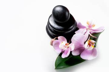 Spa still life with stack of stones, orchid flower and leaf isolated on white.