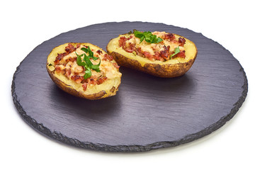 Hot Baked stuffed Potatoes with cheese, bacon, parsley, close-up, isolated on white background