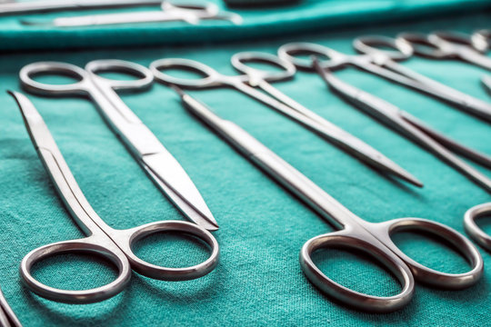 Some scissors for surgery in an operating theater, conceptual image, horizontal composition