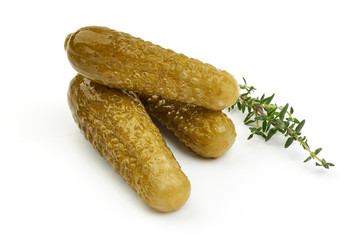 Marinated cucumbers, pickles or gherkin, salted cornichon, close-up, isolated on white background