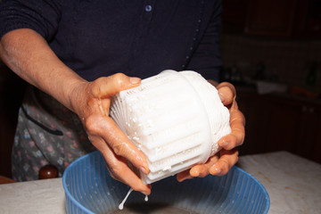 preparation of home-made cheese by an elderly housewife