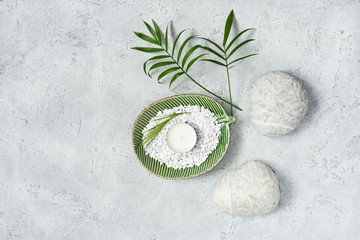 Spa stones and leaves on grey background