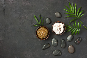 Cosmetics for spa on dark background top view